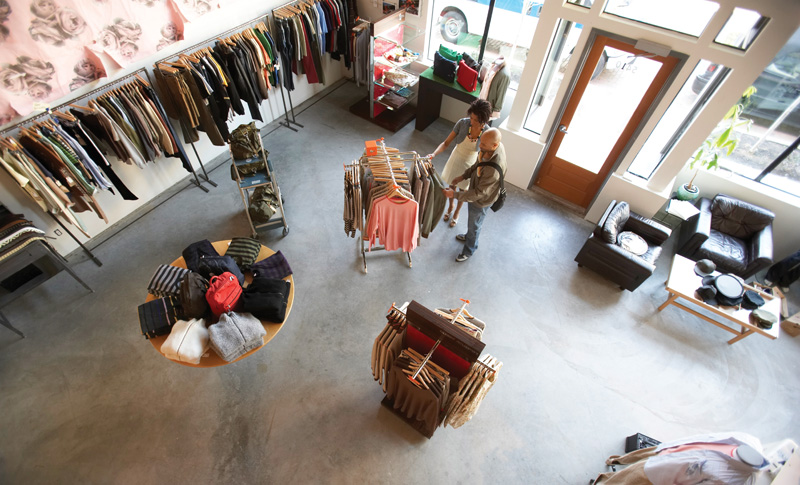 Man and woman looking at clothing in retail store, elevated view